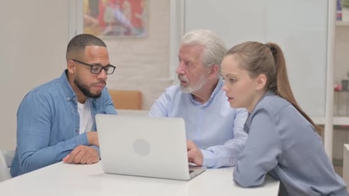 Business Colleagues Working Together at a Laptop
