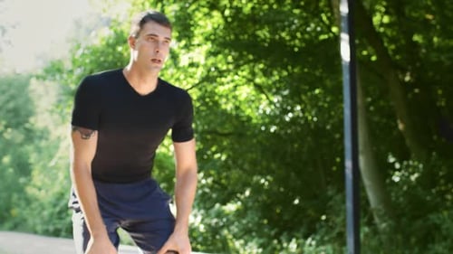 Young Man Jogging in a Park During Summer Embracing a Healthy Lifestyle