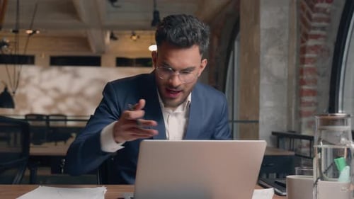 Frustrated Man Throws Papers During Video Call