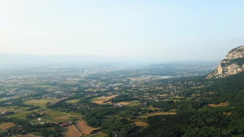 Pull out drone shot of Saleve, canton of Geneva and Lake of Geneva at sunset