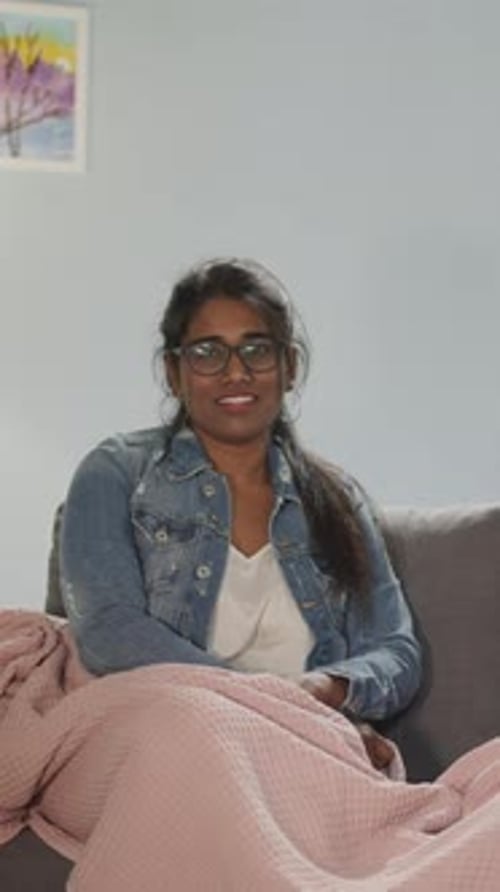 Woman Talking on Couch with Pink Blanket