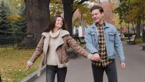 Cheerful Two Young Spouses Strolling on Street in Autumn Park Happy Lovely Couple Enjoy Pleasant