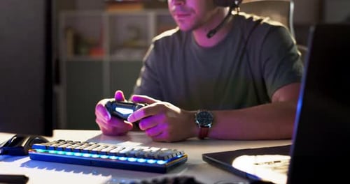 Man Playing Video Game with Controller and Headset