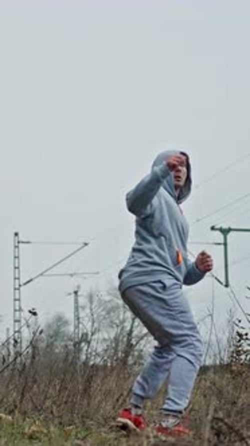 Martial Arts Outdoors Individual Executing Fighting Techniques Amid Green Natural Surroundings