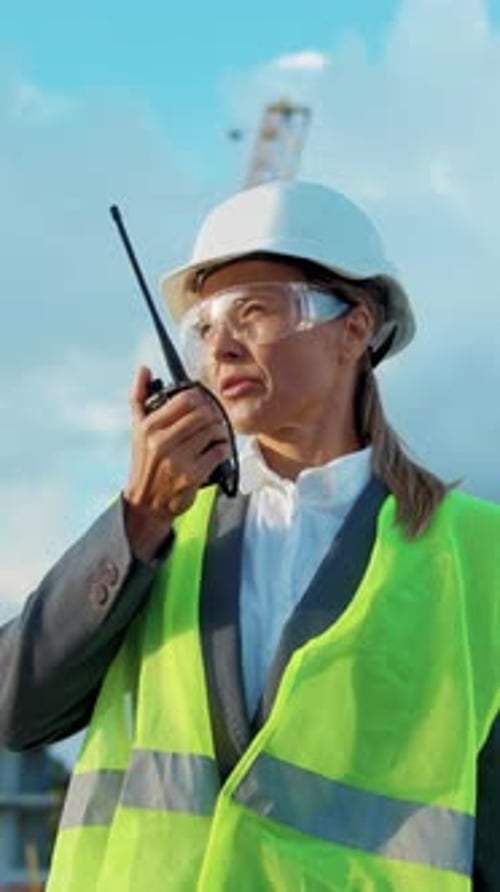 A Professional Woman in Construction Who Uses Radio Communication Effectively in Her Job