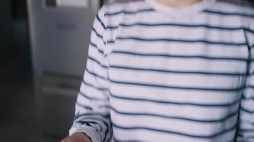 Close Up Footage of Young Woman Taking Pills with a Glass of Water at Modern Kitchen Curly Blonde