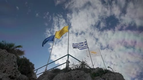 Flags Waving on Stone Structure on Sunny Day