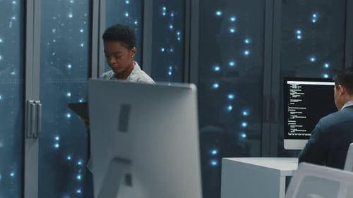 African American Data Center Woman Specialist Using Digital Tablet Cooperating in Server Room