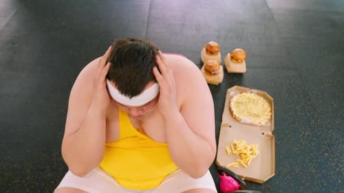 Man Looking at Unhealthy Food After Workout