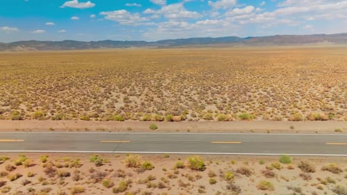 Desert highway car driving. Nevada desert road aerial shot.