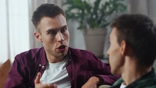 Young Adults Talking Indoors Sitting on Couch