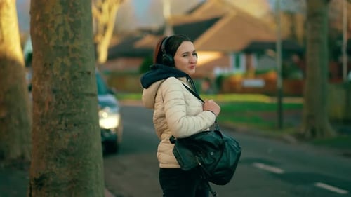 Happy Woman Wearing Headphones Dancing in Street at Residential Area Joyful Female Enjoying Music