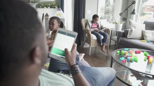 Father and Sons Relaxing in Living Room
