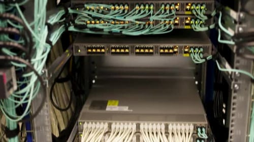 Many hard drives in a server room, close-up tilt up, datacenter