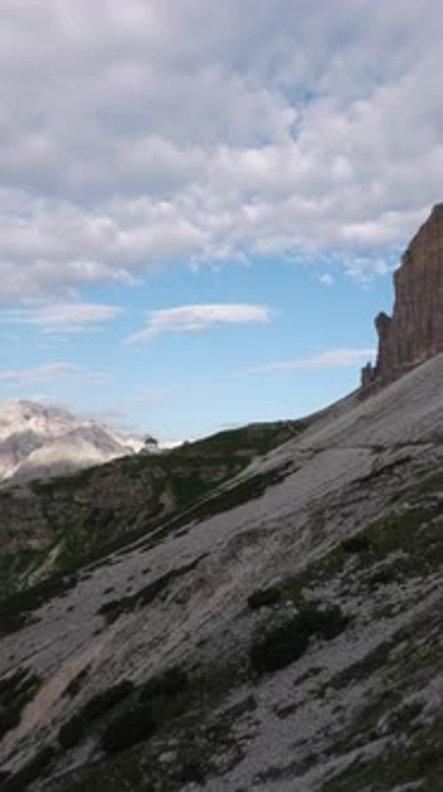 Breathtaking Rocky Mountain Alps Landscape with Steep Cliffs and Cloudy Sky - 4K