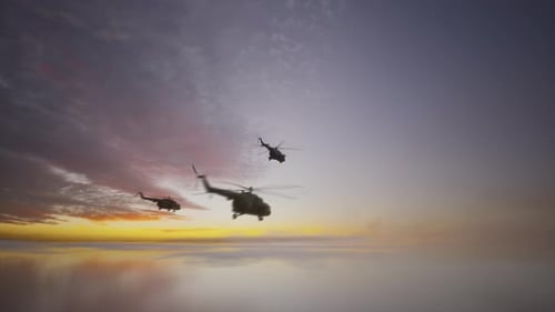 Military Helicopters Flying in Formation at Sunset