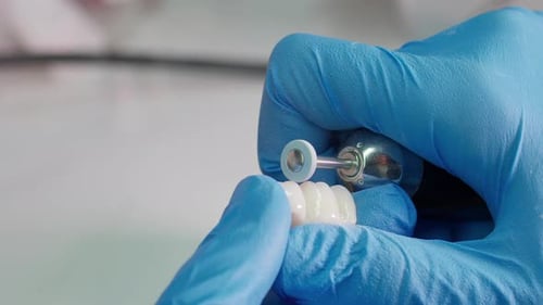 Dental Technician Working on Dental Bridge Close Up