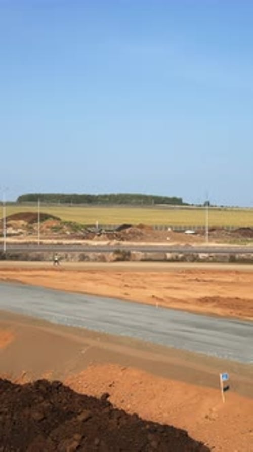 Excavator Building a New Road in Rural Landscape Clip
