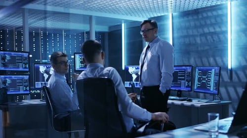 Men Discussing Data in a Server Room