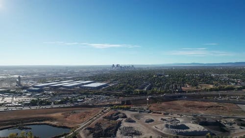 Aerial drone flyover of a busy highway in Denver, CO and industrial buildings