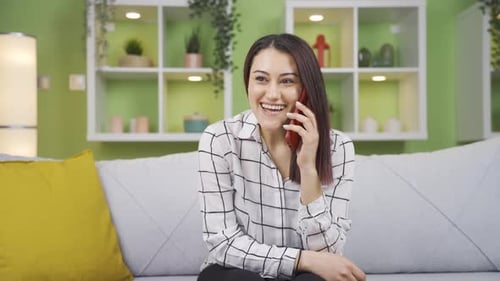 Woman Laughing on Phone Call at Home