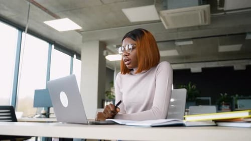 Woman Speaking During Online Meeting in Modern Office