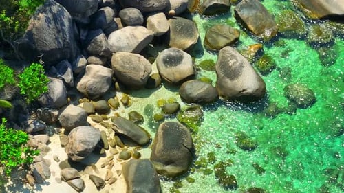 Stunning sandy beach with rock, clean sea water and green forest. 4K.