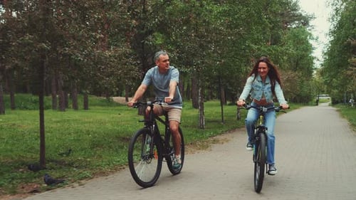 Couple Enjoying Bike Ride in Park