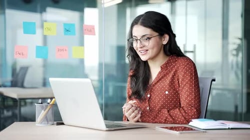 Woman Participating in a Video Conference in Office