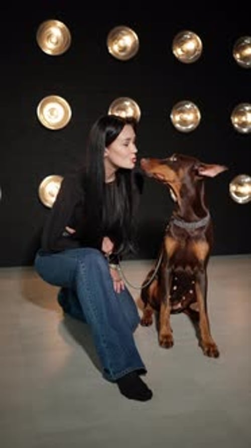 Woman with her brown doberman dog posing