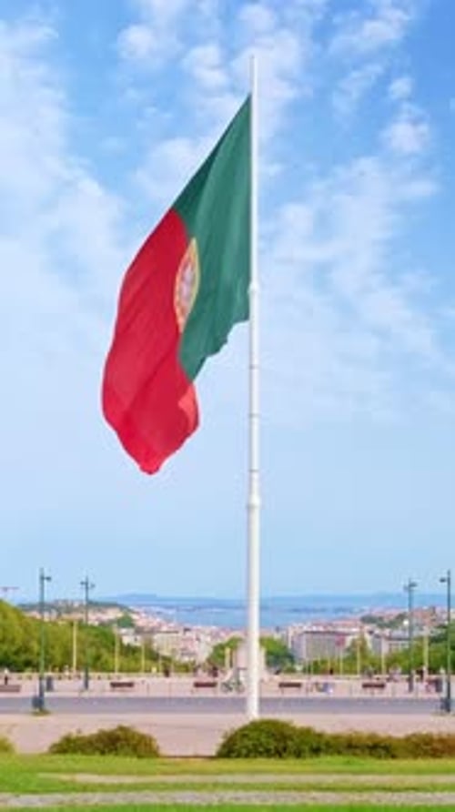 National Flag of Portugal Waving in the Wind on Clear Sunny Day at Blue Sky in Park of Edward VII