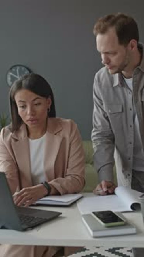 Multiethnic Colleagues Discussing Work in Office