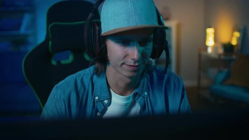 Young Man Gaming Online At Home At Night