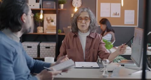 Colleagues Collaborating on Data in Modern Office