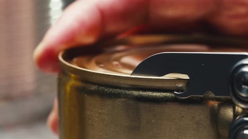 Opening Metal Tin Can with Opener, Close Up
