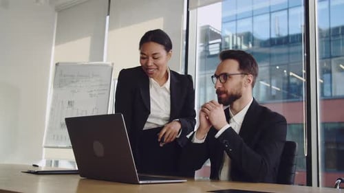 Business Colleagues Collaborate on Project in Modern Office