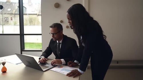 Two corporate colleagues working together in office