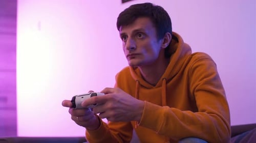 Young Adult Playing Video Game with Controller Indoors