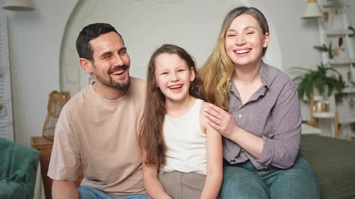 Happy Family at Home Mother Father Children Daughter Relaxing on Sofa Indoor Mom Dad Parents Kid