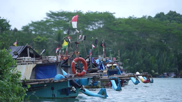 Fishermen's boats lean on the white sand beach and the blue sky of ...