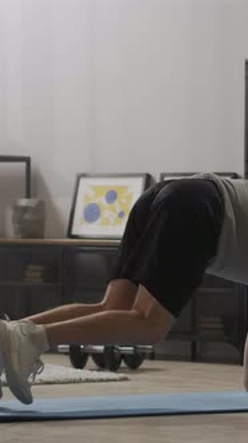 Man Does Mountain Climber Exercise on Blue Yoga Mat