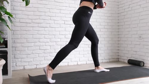 sportive woman working out doing Pilates at home