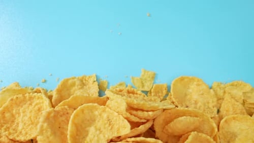 Golden Corn Flakes on a Blue Surface