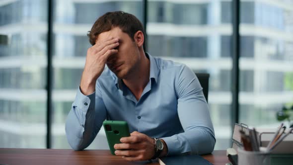 Tired Businessman Watching Mobile Phone Screen at Office. Perplexed ...