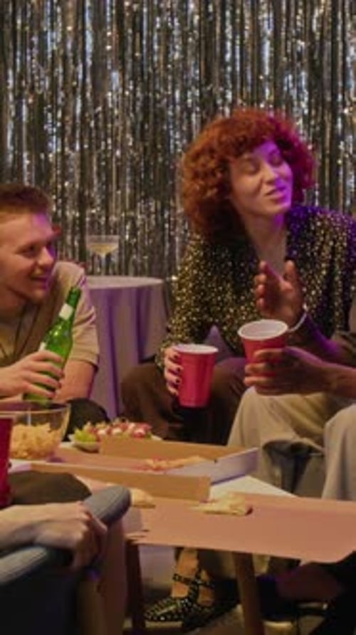 Friends Enjoying Pizza and Drinks at Home Party