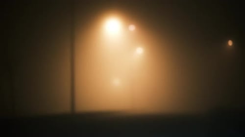 Foggy street lamps at night