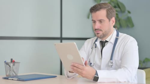Male Doctor using Tablet in Clinic