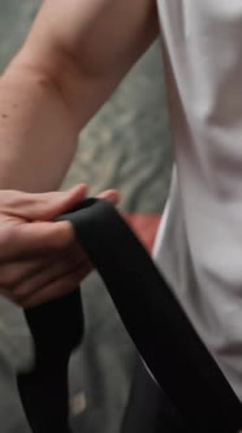 Vertical of Boxer Wrapping Hands Before Training