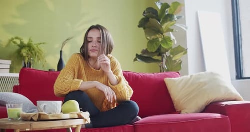 Disappointed Young Woman Throwing Smartphone Away Sitting on Couch Feeling Upset and Unwell