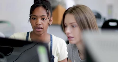 Closeup teenage girls using a computer in class